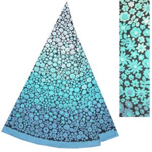 Image shows a circular, 1970's table cloth folded into a triangular shape, featuring ombre floral print from light blue to turquoise