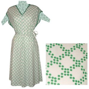 Image shows a green and white dotted vintage dress from the 1970s