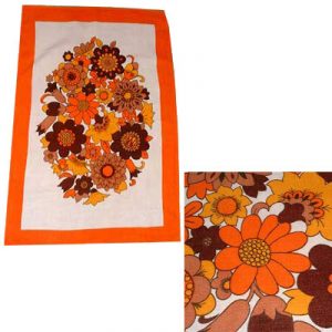 Image shows a bold, orange floral print tea towel from the 1970's