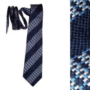 Image shows a men's neck tie from the 1970's with a blue, block design